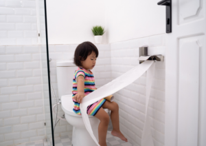 Girl sitting on toilet